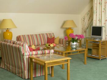 Die Suite de Luxe im Hotel Seehof Mondsee verfügt über ein buntes Wohnzimmer