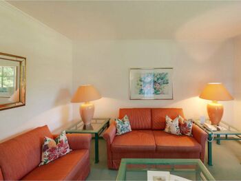 Eine orange-rote Sitzgarnitur steht in der Suite vom Hotel Seehof Mondsee