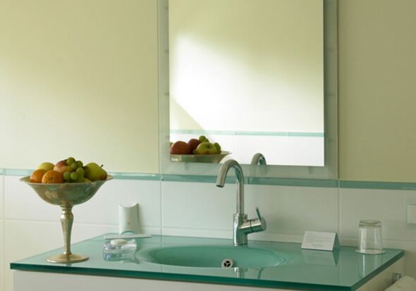 A modern bathroom with large games above the sink