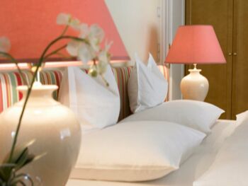 Several pillows lie on a bed