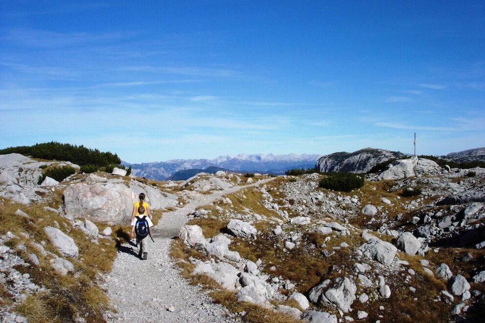 Children with backpacks are just on the home stretch on the way to the summit cross.