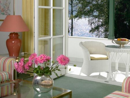 The suite at Hotel Seehof has a sofa, a coffee table and a balcony with lake view